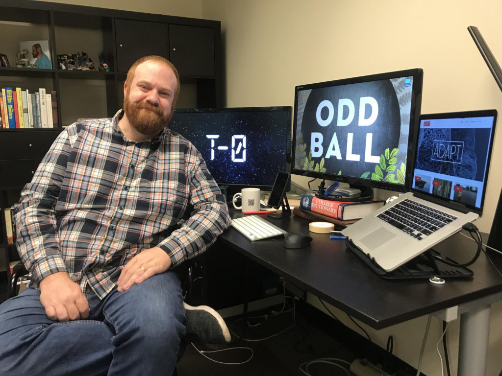 Ray Hollister sitting in front of his computer and screens